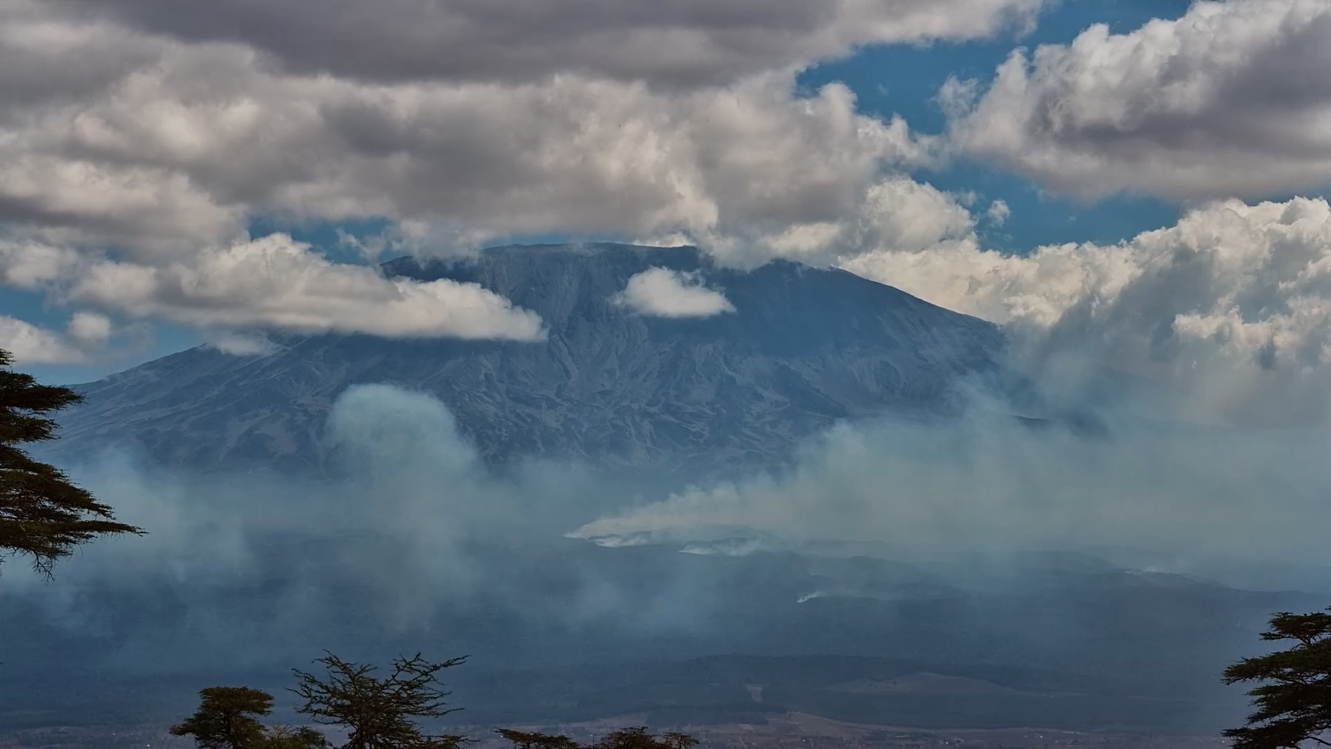 Clouds and Smoke Swirl Around Mount Kilimanjaro