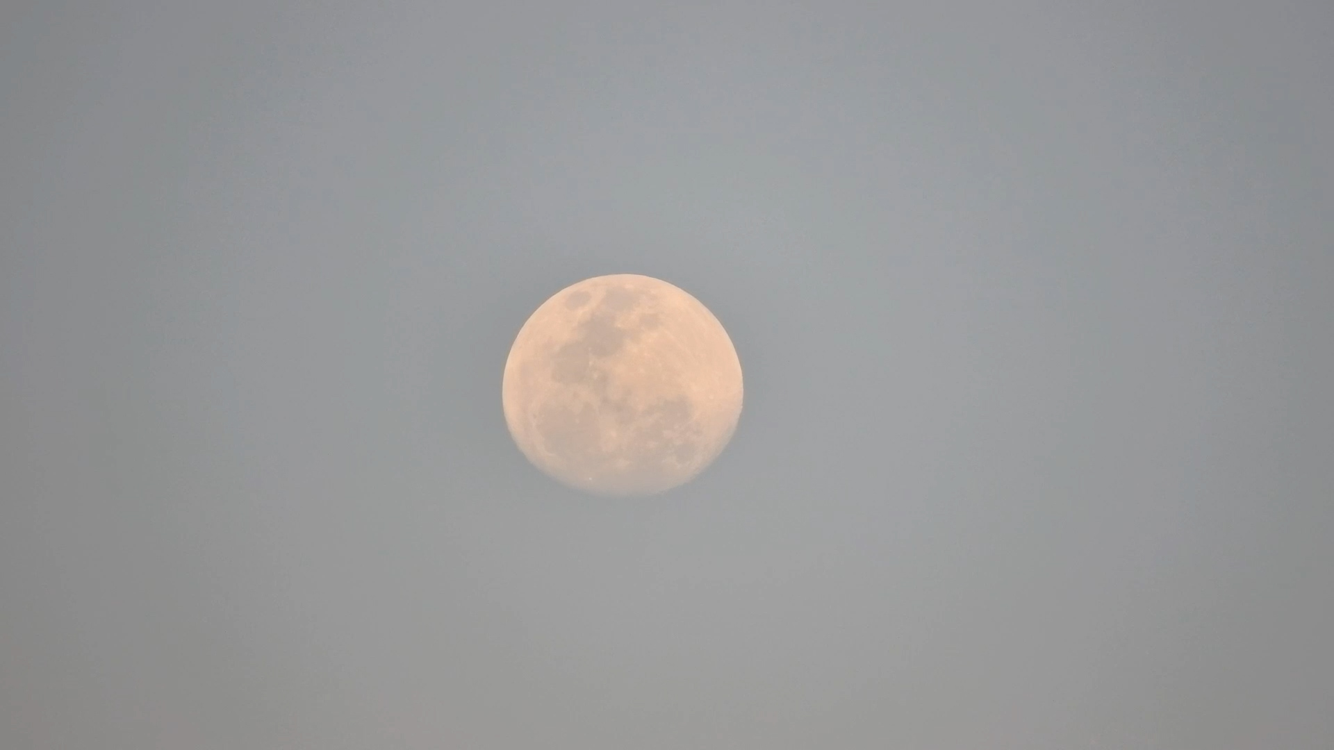 A Beautiful Moonrise Beneath a Soft Blue Sky